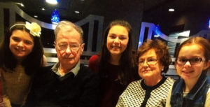 Care Dimensions patient Norman Brown with his wife, granddaughter, and great-grandchildren