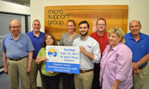 Bruce Billingham and employees of Micro Support Group promoting Care Dimensions' 30th Walk for Hospice