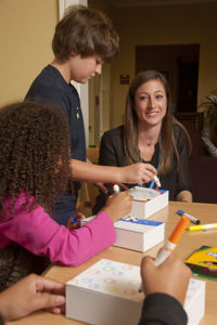 Grieving children make memory boxes with Care Dimensions child life specialist