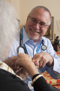 Robert Taylor, MD, Care Dimensions associate medical director for Greater Boston, speaks with hospice patient at home