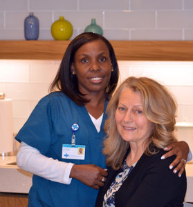 Care Dimensions hospice aide Guerline Dorvelus with female patient in kitchen