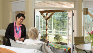 Nurse Trudy Miller speaks with patient at Care Dimensions Hospice House in Lincoln Massachusetts