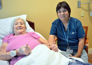 Care Dimensions Hospice Aide Cindy Berry with female patient at Kaplan Family Hospice House