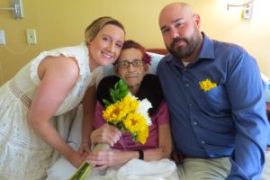 Newlyweds Spencer and Joe Newton pose with bride's mother a patient at Care Dimensions' Kaplan Family Hospice House