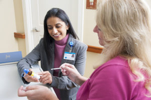 Care Dimensions Director of Pharmacy Services Alifia Waliji-Bangawala, Pharm.D, reviews medication with hospice nurse